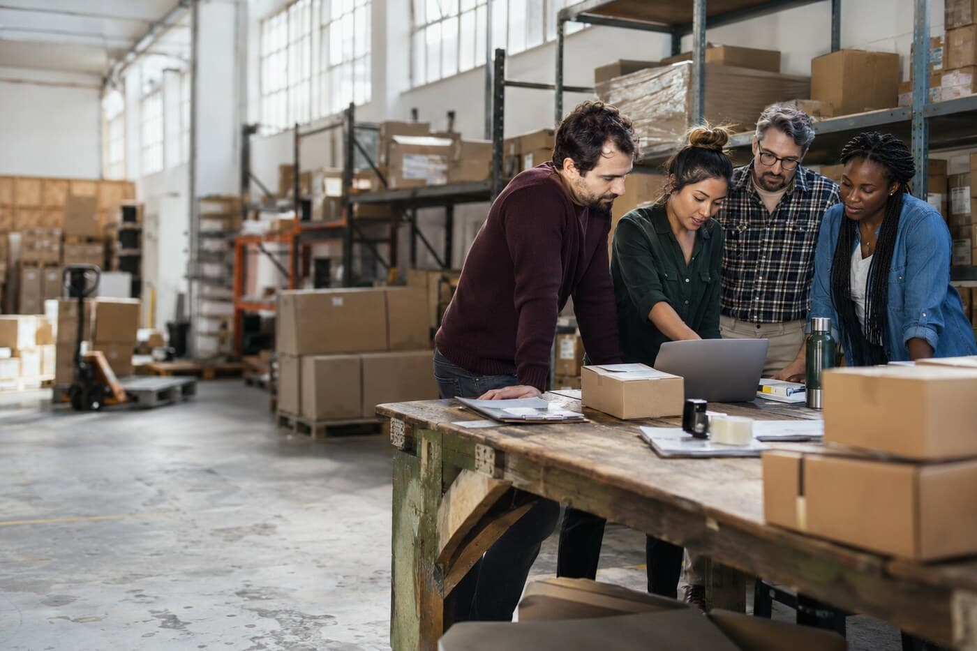 Small business team planning together in a warehouse